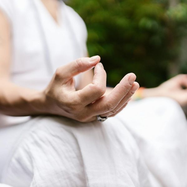 Detail of hands in a yoga mudra position during meditation